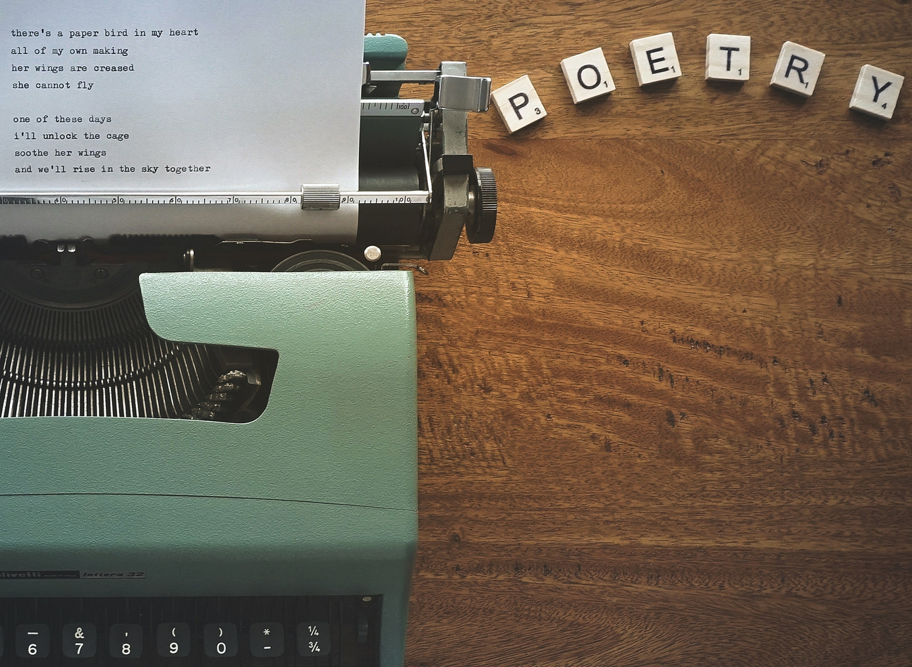 Scrabble Tiles Near a Typewriter